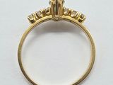 a close up of a gold ring with diamonds on it
