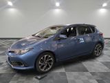 a blue toyota corolla parked on a checkered tile floor
