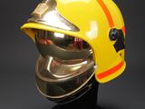 a close up of a helmet on a stand on a black background