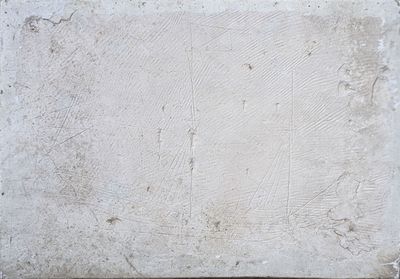 concrete wall with a square pattern of white paint on it