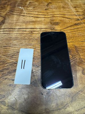 an image of a black cell phone sitting on top of a wooden table