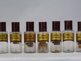 six bottles of different types of perfume are lined up on a table