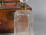 two bottles of perfume sitting next to each other on a table