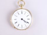 a gold pocket watch with roman numerals on the face