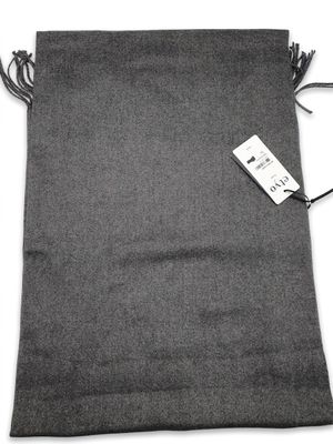 a gray bag with a tag on it sitting on a white surface