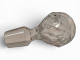 a glass bottle with a metal handle on a white surface