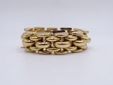 a close up of a stack of gold rings on a white surface
