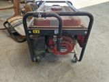 a small generator that is sitting in the garage