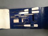 a picture of a set of scissors and other tools in a blue case