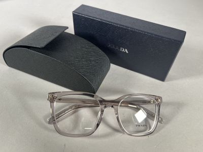 sunglasses in a box and a pair of glasses on a table