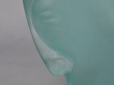 a close up of a glass vase on a white surface