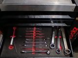 a tool drawer with tools inside of it in a garage
