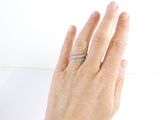 a woman ' s hand with a diamond ring on it
