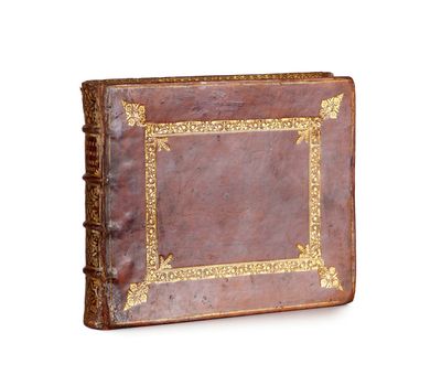 an old book with a gold border on a white background