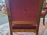 a chair with a red upholstered seat and a wooden frame