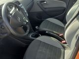 the interior of a car with the door open and the driver ' s seat down