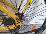a close up of a yellow bicycle with a black tire