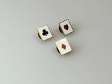 a pair of gold and black playing cards on a white surface