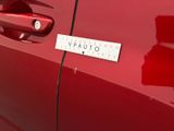 a close up of a red car with a sticker on it