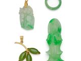 an assortment of jade and gold jewelry including a jade head, a jade ring, and a jade ring