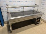 une photo d'une table en acier inoxydable avec un plateau en verre