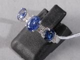 an image of a ring with three sapphires on it