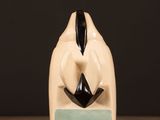 a ceramic sculpture of a man with a mustache on a table