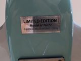 a close up of a blue toilet seat with a sign on it