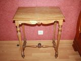 a small wooden table with a drawer on top of it