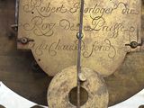a clock that has angels on it with writing on it