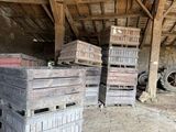 many crates stacked on top of each other in a barn