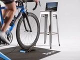 a man that is riding a bike on a stand