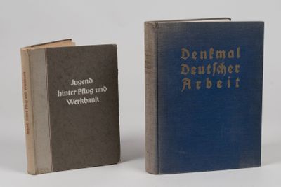 two books sitting next to each other on a white surface