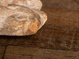 a piece of bread that is sitting on a wooden table