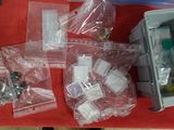 many bags of electronic equipment sitting on a table