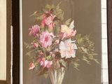 two framed pictures of flowers in a vase on the wall