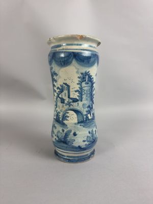 un vase bleu et blanc posé sur une surface blanche