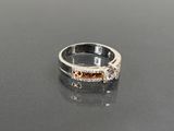 a diamond ring on a table with a black surface