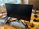 an image of a desk with a computer monitor and other electronics