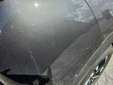 a close up of a car ' s front bumper with scratches on it