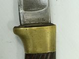 a close up of a knife on a white surface