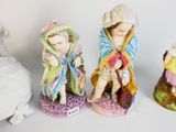 three figurines of a woman, a man and a child