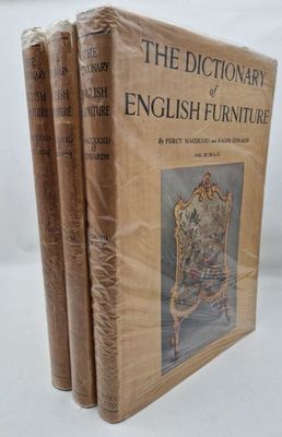 three books sitting on top of each other on a white surface