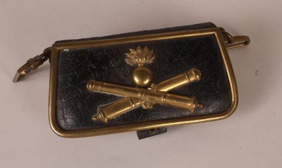 a black purse with a gold skull and crossbones on it