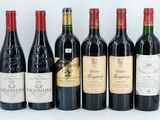 six bottles of wine are lined up in a row on a table