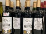 several bottles of wine are lined up on a counter