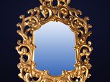 an ornate gold mirror with a blue background