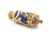 a blue and gold object on a white surface