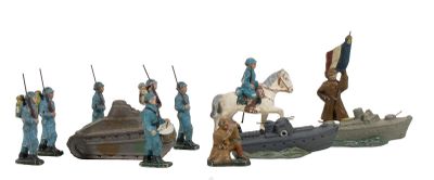 several figurines of men in blue uniforms riding horses and a boat