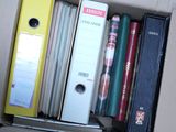 a box full of books and binders on a table